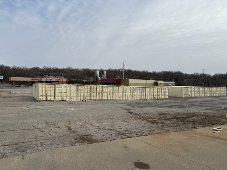 Large outdoor storage facility with tan-colored modular containers arranged in rows on a concrete lot under overcast sky